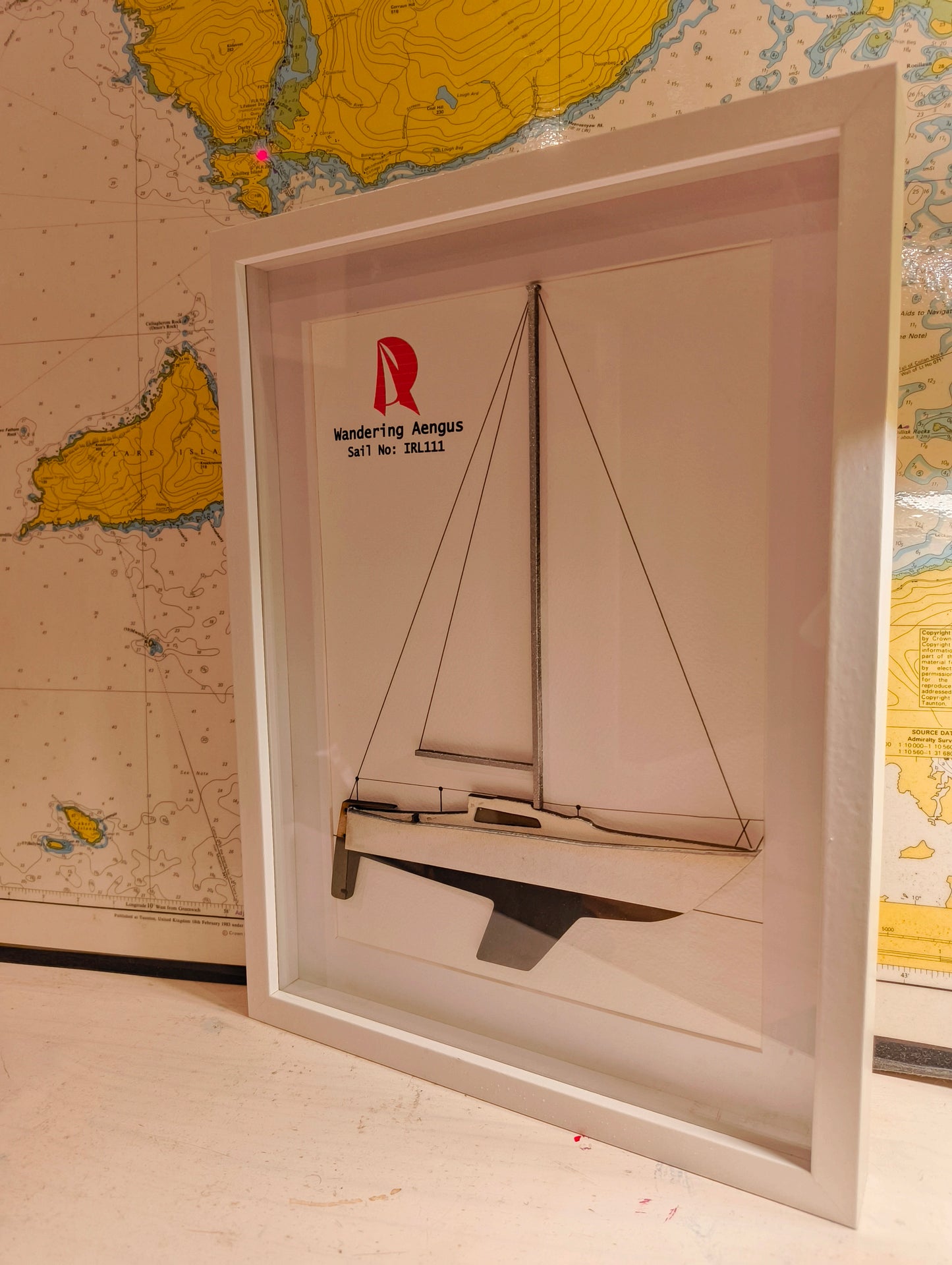Multi-layered wooden sailboat wall art.